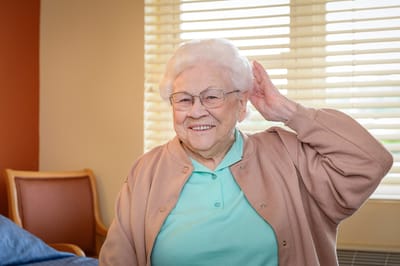 Elderly woman smiling in a cozy room