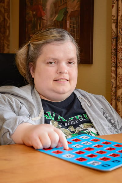 Resident playing bingo in an activity room