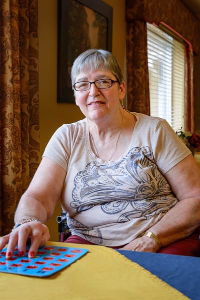 Resident enjoying a game of bingo indoors