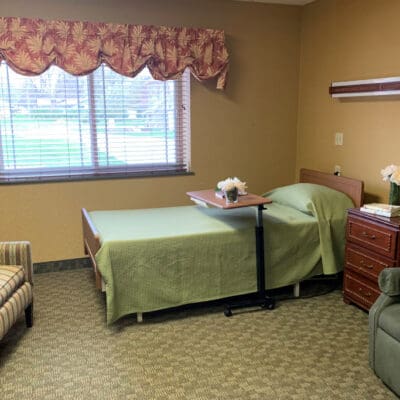 Private resident room with a bed and seating area