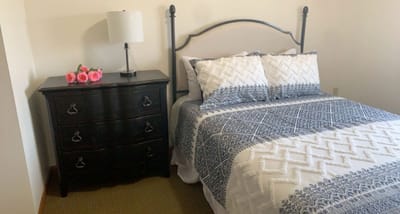Cozy resident room with a bed and dresser