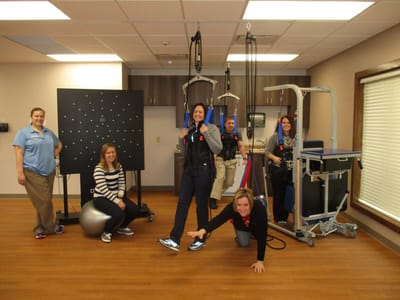 Residents participating in a therapy session with staff support