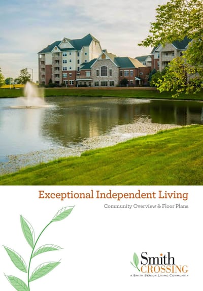 Exterior view of a senior living community by a pond