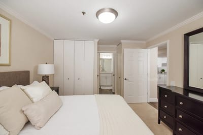 A well-furnished private bedroom in a senior living facility