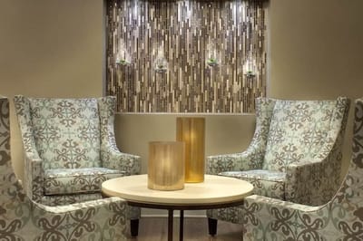 Cozy lounge area with patterned chairs and decorative wall