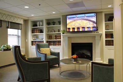 A cozy lounge area with seating and a fireplace