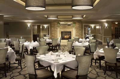 Elegant dining room with set tables and fireplace