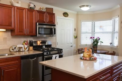 Bright kitchen with wooden cabinets and appliances