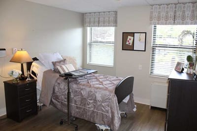 Cozy resident room with a bed and windows