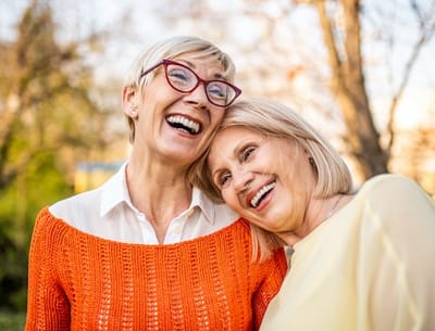 Two smiling women enjoying time outdoors