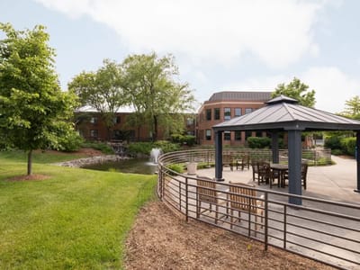 Scenic outdoor area with gazebo and pond