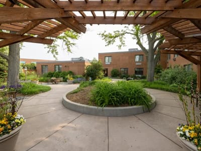 Green outdoor space with flowers and seating area
