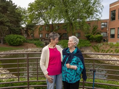 Two residents enjoying a moment by the pond