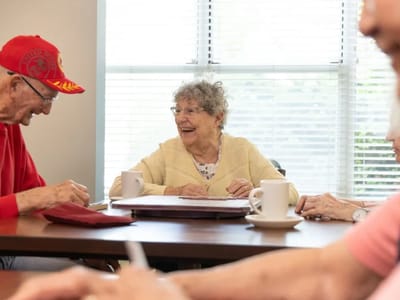 Residents engaged in conversation at a table