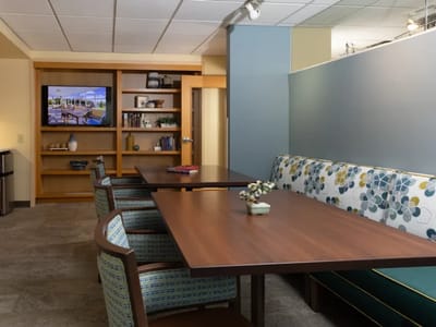 Cozy common area with tables and a TV