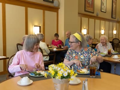 Residents enjoying a meal together in the dining room