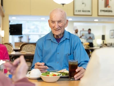 A senior enjoying a meal in the dining room