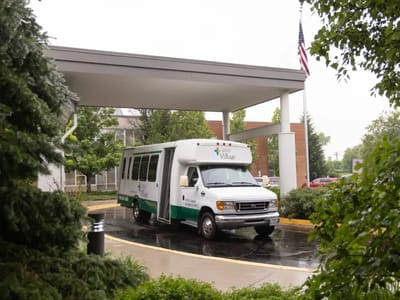Facility transport vehicle under a covered entrance