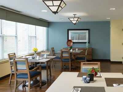 Bright dining room with tables and chairs.