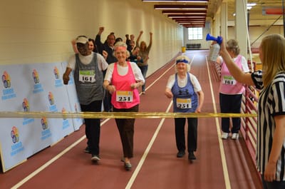 Seniors participating in a fun race event indoors
