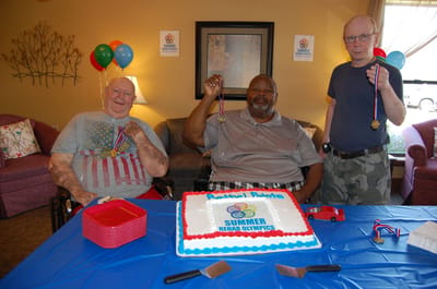 Residents celebrating with medals at a community event