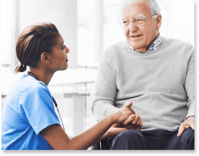 Caregiver engaging with a resident in a bright facility setting