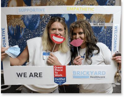 Staff members posing with fun props and smiles