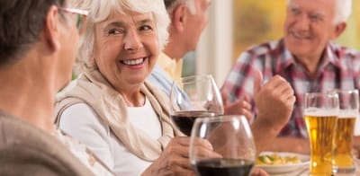 Seniors enjoying food and drinks at a social gathering