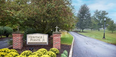 Signage for Heritage Pointe near a landscaped drive