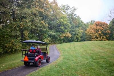 Residents enjoying a scenic ride in a golf cart