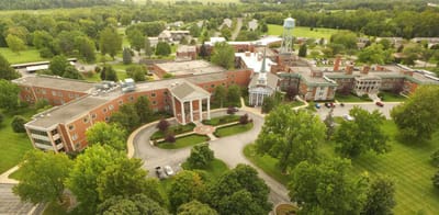 Aerial view of a senior living facility surrounded by greenery