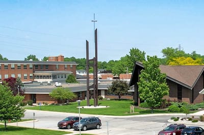 Exterior view of a senior living facility with gardens