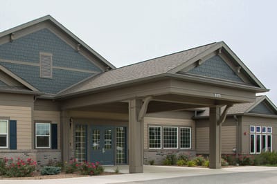 Entrance of a senior living facility with landscaped garden