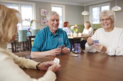Residents playing cards in a common area