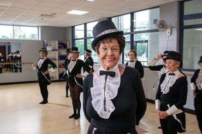 Residents participating in a dance class in a studio