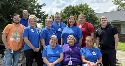 Group of staff members posing outdoors