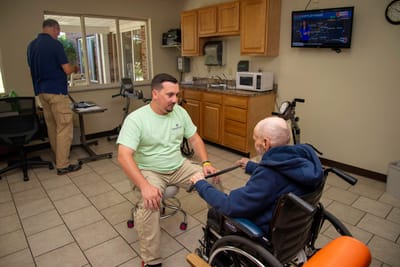 Staff member assisting a resident in a common area