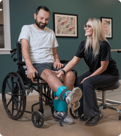 Therapist assisting a resident in a rehabilitation session