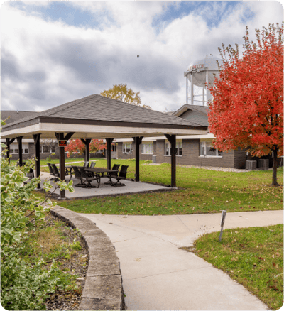 Outdoor gazebo area with colorful autumn trees
