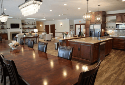Bright common area with dining table and kitchen