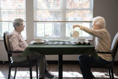 Two residents enjoying a meal together
