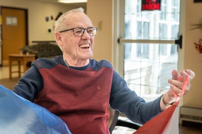 Resident enjoying a colorful activity with smiles
