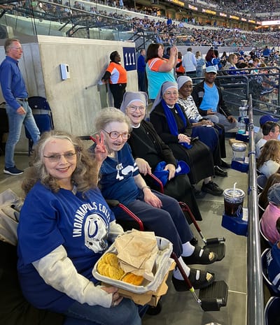 Residents enjoying a football game with snacks