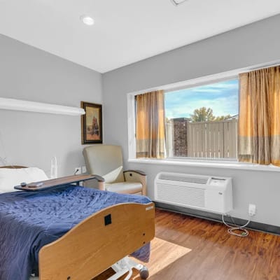 Private resident room with a window and chair