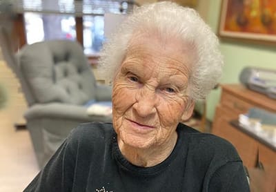Elderly woman smiling in a cozy interior