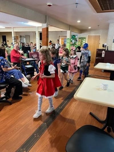 Children in costumes participating in a lively event