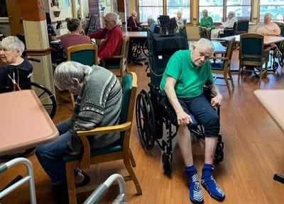 Residents relaxing in a common area with tables