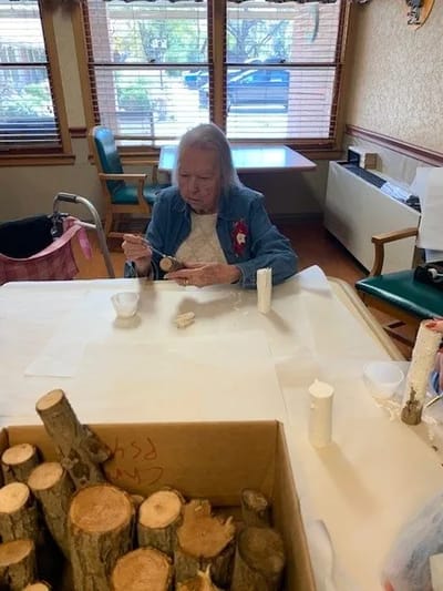 Resident engaged in a craft activity indoors