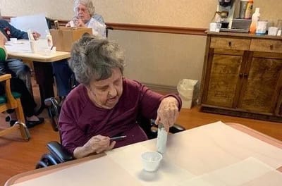 Resident participating in an activity at a table