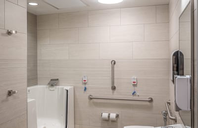 Accessible bathroom with walk-in tub and grab bars